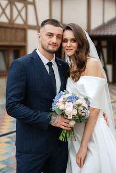 the first meeting of the bride and groom in wedding outfits in the park