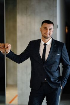 portrait of a bearded groom guy in a dark blue suit