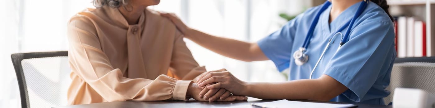 Young asian woman or nurse care hand on senior grandmother shoulder give support empathy to elderly lady or older people