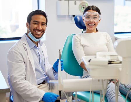 My teeth look amazing thanks to my dentist. Portrait of a young woman having a consultation with her patient in a dentists office