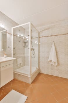 a bathroom with tile flooring and white tiles on the walls, along with a walk - in shower stall