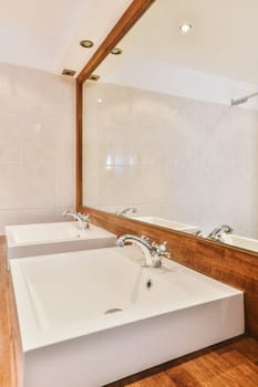 a bathroom with two sinks and a mirror on the wall next to the bathtub is in front of it