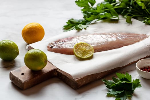 cooking of the sole flatfish meuniere style, raw fish and other ingredients on the table
