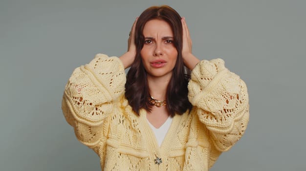 Dont want to hear and listen. Frustrated annoyed irritated one pretty woman covering ears gesturing No, avoiding advice ignoring unpleasant noise loud voices. Young girl on studio gray background
