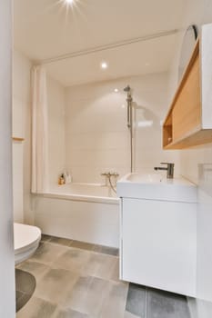 a small bathroom with a toilet and bathtub on the floor next to a sink in front of a window