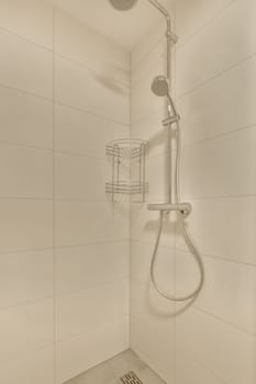 a shower room with white tile walls and beige tiles on the wall, there is a basket in the shower