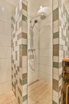 a bathroom with tiled walls and wood flooring on the shower wall, there is a wooden bench in the corner