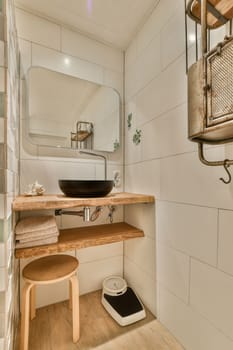 a bathroom with a sink, mirror and towel rack on the wall next to it is a wooden bench that has been used for