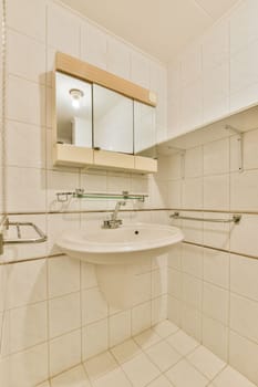 a bathroom with a sink and mirror on the wall next to each other areas in the area is white tile