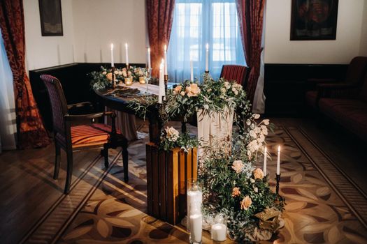 wedding table decoration with flowers on the table in the castle, table decor for dinner by candlelight.Dinner with candles.