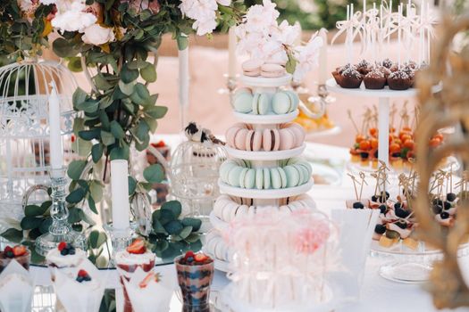 Sweet table at the wedding. Table with cakes and sweets at the festival.