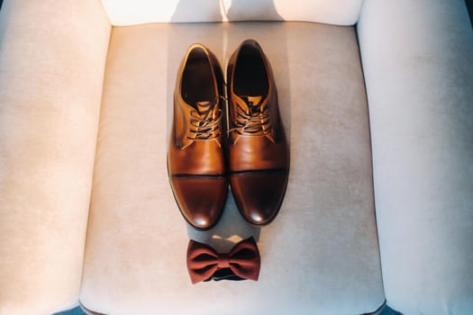 brown bow tie on a light background and boots