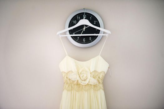 Vintage Wedding dress hanging on a wooden hanger.