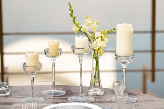 wedding table decoration with flowers on the table in the castle, table decor for dinner by candlelight.Dinner with candles.