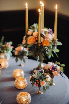 wedding table decoration with flowers on the table in the castle, table decor for dinner by candlelight.Dinner with candles.