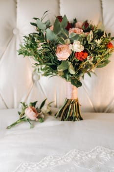 wedding bouquet with roses and boutonniere.The decor at the wedding.