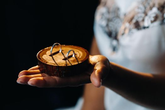 Close-up of two gold wedding rings for the wedding lie on the hand.