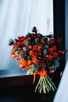 wedding bouquet with roses and boutonniere.The decor at the wedding.