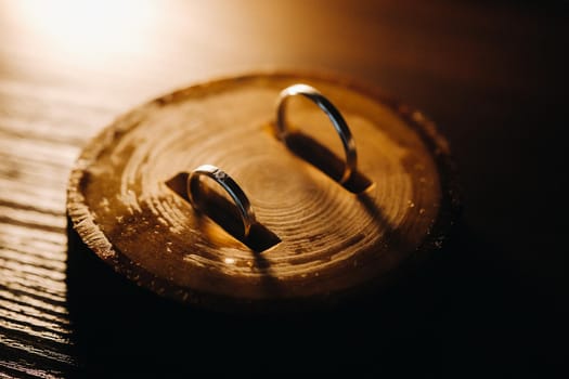 Close-up of two gold wedding rings lying on a wooden Board.Wedding ring.Wedding ring