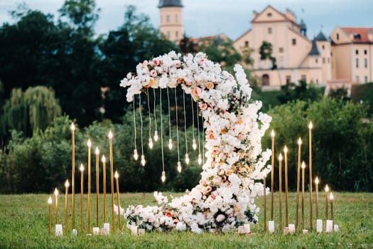 Wedding ceremony on b street near the Nesvizh castle.Decor with fresh flowers in the form of the moon