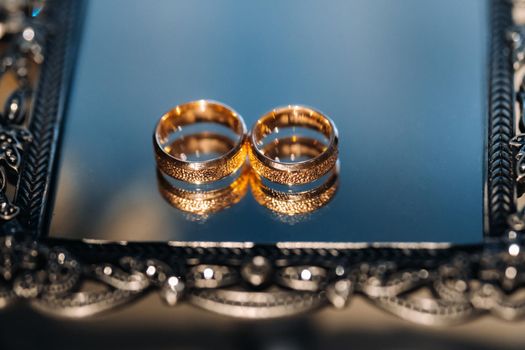 Close-up of two gold wedding rings for a wedding.