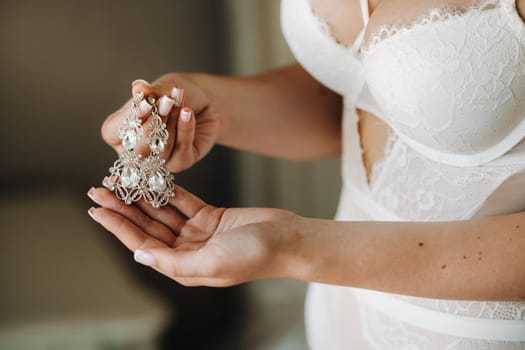 Accessories for the bride. Earrings on the veil. White wedding earrings. Space for text and ads