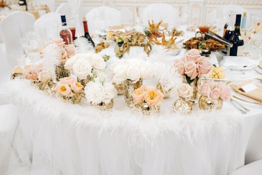 wedding table decoration with flowers on the table in the castle, table decor for dinner by candlelight.Dinner with candles.