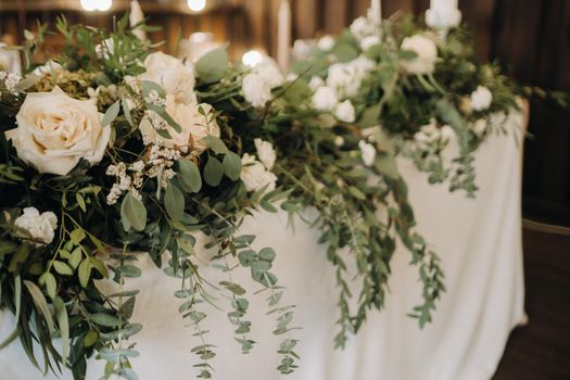 wedding table decoration with flowers on the table in the castle, table decor for dinner by candlelight.Dinner with candles.