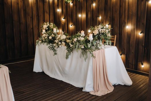 wedding table decoration with flowers on the table in the castle, table decor for dinner by candlelight.Dinner with candles.