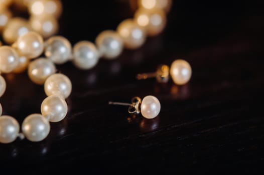 Accessories for the bride. Earrings and a bracelet. White wedding earrings