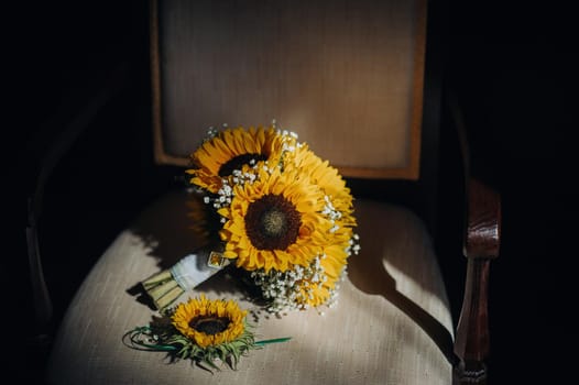 a wedding bouquet of sunflowers lies on an antique chair.Wedding Decor.