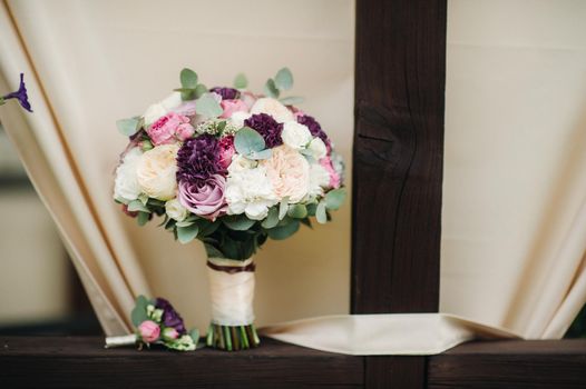 wedding bouquet with roses and boutonniere.The decor at the wedding.