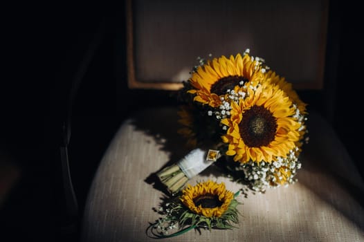 a wedding bouquet of sunflowers lies on an antique chair.Wedding Decor.