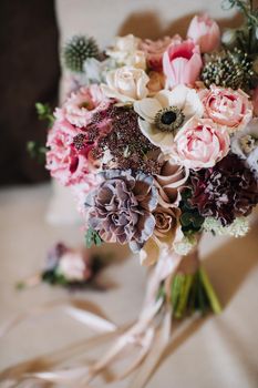 wedding bouquet with roses and boutonniere.The decor at the wedding.