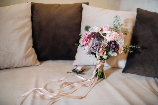 wedding bouquet with roses and boutonniere.The decor at the wedding.