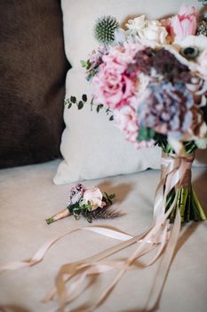 wedding bouquet with roses and boutonniere.The decor at the wedding.