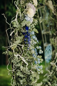 Wedding ceremony on the street on the green lawn.Decor with fresh flowers arches for the ceremony.