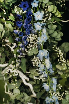 Wedding ceremony on the street on the green lawn.Decor with fresh flowers arches for the ceremony.