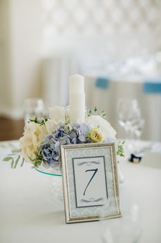 wedding table decoration with blue flowers on the table in the restaurant table decor for dinner at the wedding