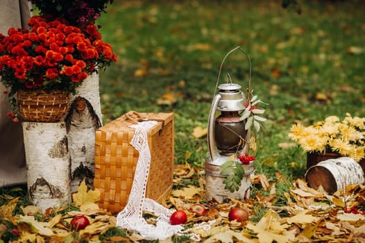 Autumn wedding ceremony on the street on the green lawn.Decor with arches of fresh flowers for the ceremony.