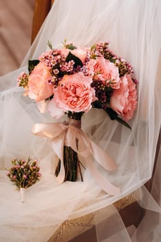 wedding bouquet with roses and boutonniere.The decor at the wedding.