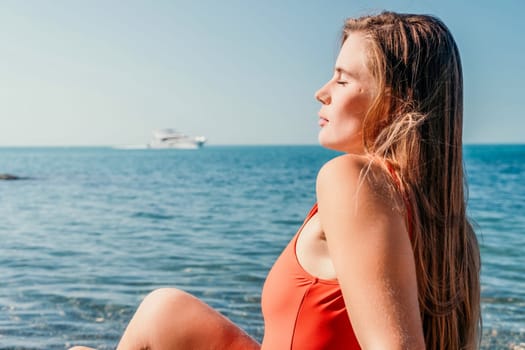 Sexy young woman in stylish bikini lying on seashore, closeup. Holiday, vacation and recreational concept.