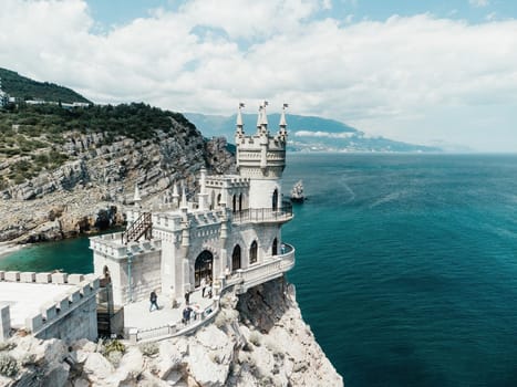 Aerial view of Swallow's Nest castle on the rock in Black Sea. It is a symbol and landmark of Crimea. Beautiful scenic panorama of the Crimea coast. Amazing Swallow's Nest at the precipice.