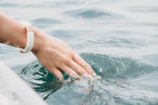 Woman in kayak back view. Happy young woman with long hair floating in transparent kayak on the crystal clear sea. Summer holiday vacation and cheerful female people having fun on the boat.