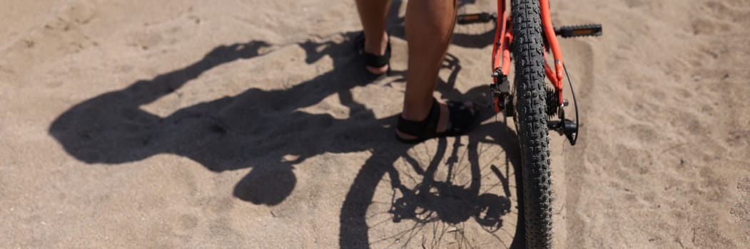 Rear wheel of mountain bike and rider leg. Rear shot of mountain bike on dirt road and closeup of mountain bike tire