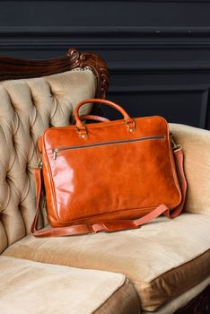 close-up photo of orange leather bag corporate. Indoor photo