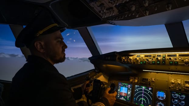 A man is studying to be a pilot in an aircraft simulator