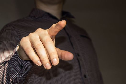 Businessman pointing finger at blank virtual screen by pressing virtual button