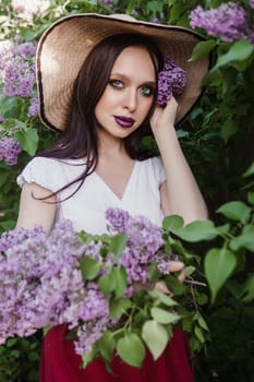 A fashionable girl with dark hair, a spring portrait in lilac tones in summer. Bright professional makeup