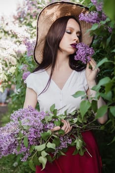 A fashionable girl with dark hair, a spring portrait in lilac tones in summer. Bright professional makeup